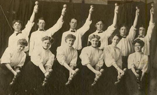 Group photo of the Normal School's first female physical education club in their physical education uniforms. In the back row are the members of the male physical education club.